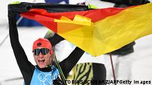 Germany's Vinzenz Geiger celebrates after winning the cross-country race of the Nordic Combined men's individual normal hill/10km event during the Beijing 2022 Winter Olympic Games at the Zhangjiakou National Cross-Country Skiing Centre on February 9, 2022. (Photo by Tobias SCHWARZ / AFP) (Photo by TOBIAS SCHWARZ/AFP via Getty Images)