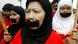 A woman in a hijab with tape over her mouth A woman in a hijab with tape over her mouth