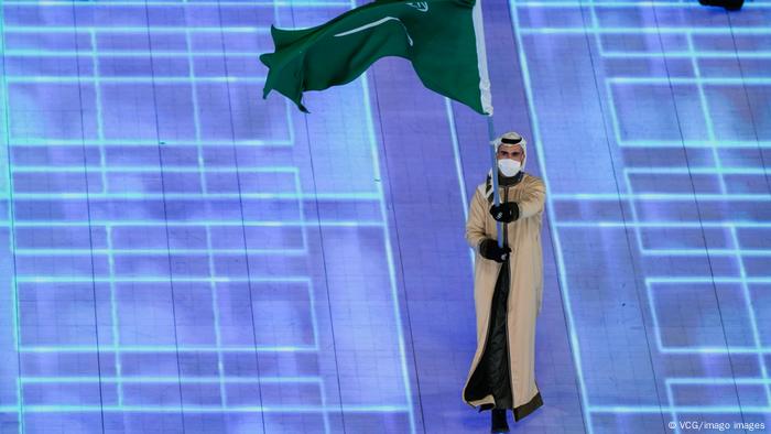 Flag bearer Fayik Abdi of Team Saudi Arabia carries their flag during the opening ceremony