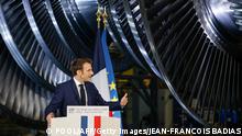 TOPSHOT - French President Emmanuel Macron delivers a speech at the GE Steam Power System main production site for its nuclear turbine systems in Belfort, eastern France, on February 10, 2022, as part of a visit dedicated to energy policy and the future of the country's atomic industry, which provides around 70 percent of French electricity. - French President Emmanuel Macron is set to throw his support behind a massive nuclear power plant programme during his visit, despite concerns about the cost and complexity of building new reactors. (Photo by Jean-Francois Badias / POOL / AFP) (Photo by JEAN-FRANCOIS BADIAS/POOL/AFP via Getty Images)