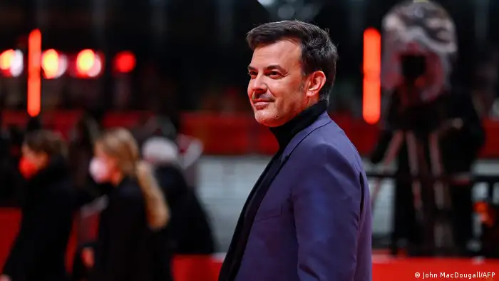 Francois Ozon poses for photographers on the red carpet.