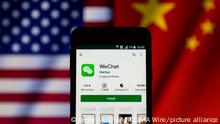 September 20, 2020, Asuncion, Paraguay: Illustration photo - App icon of WeChat, a messaging app developed by Tencent, on Google Play app store is displayed on a smartphone screen backdropped by cropped waving flags of United States and China. (Credit Image: Â© Andre M. Chang/ZUMA Wire
