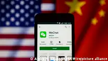 September 20, 2020, Asuncion, Paraguay: Illustration photo - App icon of WeChat, a messaging app developed by Tencent, on Google Play app store is displayed on a smartphone screen backdropped by cropped waving flags of United States and China. (Credit Image: Â© Andre M. Chang/ZUMA Wire
