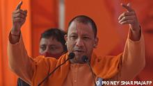 (FILES) In this file photo taken on February 1, 2022, the chief minister of India's Uttar Pradesh state Yogi Adityanath gestures as he speaks during an election campaign rally in Modinagar in Ghaziabad district, some 45km east of New Delhi. - A firebrand monk known for his incendiary anti-Muslim rhetoric leads the Hindu nationalist Bharatiya Janata Party into elections in India's most populous state February 10, 2022, where a resounding victory could put him in pole position to succeed Prime Minister Narendra Modi. (Photo by Money SHARMA / AFP)