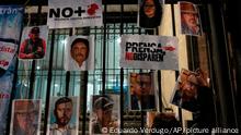 A woman posts photos of murdered journalists during a national protest against the murder of journalists Lourdes Maldonado and freelance photojournalist Margarito Martínez, in Mexico City, Tuesday, Jan. 25, 2022. Mexico's Interior Undersecretary Alejandro Encinas said recently that more than 90% of murders of journalists and rights defenders remain unresolved, despite a government system meant to protect them. (AP Photo/Eduardo Verdugo)