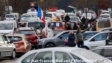 Protesters gather for a convoy before heading to Paris, Friday, Feb.11, 2022 in Strasbourg, eastern France. Authorities in France and Belgium have banned road blockades threatened by groups organizing online against COVID-19 restrictions. The events are in part inspired by protesters in Canada. Citing risks of trouble to public order, the Paris police department banned protests aimed at blocking the capital from Friday through Monday. (AP Photo/Jean-Francois Badias)