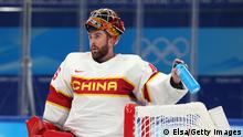 BEIJING, CHINA - FEBRUARY 10: Shimisi Jieruimi #45 of Team China reacts during the second period of the game against Team China during the Men's Ice Hockey Preliminary Round Group A match on Day 6 of the Beijing 2022 Winter Olympic Games at National Indoor Stadium on February 10, 2022 in Beijing, China. (Photo by Elsa/Getty Images)