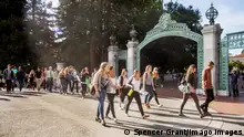 Multiracial students walk past Sather Gate on the campus of the University of California at Berkeley.