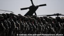 US soldiers line up during the visit of NATO Secretary General Jens Stoltenberg at the Mihail Kogalniceanu airbase, near the Black Sea port city of Constanta, eastern Romania, Friday, Feb. 11, 2022. Stoltenberg paid an official visit to Romania on Friday, where he joined the country's president Klaus Iohannis at a military airbase that will host some of the 1,000 U.S. troops deployed to the country as the alliance bolsters its forces on the eastern flank as tensions soar between Russia and Ukraine. (AP Photo/Andreea Alexandru)