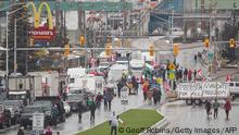 Anti-vaccine mandate protestors block the roadway at the Ambassador Bridge border crossing, in Windsor, Ontario on February 11, 2022. - The protestors who are in support of the Truckers Freedom Convoy in Ottawa have blocked traffic in the Canada bound lanes from the bridge since February 7, 2022. Approximately $323 million worth of goods cross the Windsor-Detroit border each day at the Ambassador Bridge making it North Americas busiest international border crossing. (Photo by Geoff Robins / AFP) (Photo by GEOFF ROBINS/AFP via Getty Images)