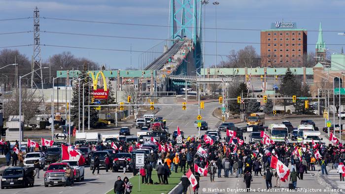 Police confronting protesters at the Ambassador Bridge