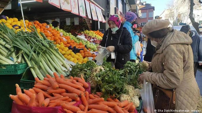 Women at an open-air fruit and vegetable stand in Istanbul