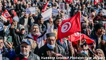 Demonstrators gather during a protest against Tunisian President Kais Saied in Tunis, Tunisia, Sunday, Feb. 13, 2022. (AP Photo/Hassene Dridi)