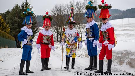 Young men in colorful traditional costumes in Hamry, Czech Republic. February 12, 2022. 