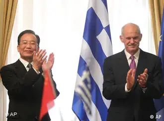 Greek Prime minister George Papandreou, right, and his Chinese counterpart Wen Jiabao , clap hands during the signing ceremony of 11 private business deals and two state cooperation agreements for trade and cultural affairs between the two countries in Athens, Saturday, Oct. 2, 2010. Chinese Premier Wen Jiabao vowed Saturday to double trade with Greece within five years, and to buy Greek bonds when the crisis-hit country returns to international markets. (AP Photo/Petros Giannakouris)
