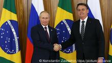 6074614 14.11.2019 Russian President Vladimir Putin and Brazilian President Jair Bolsonaro shake hands as they pose for a photo prior to their meeting on the sidelines of the 11th BRICS leaders summit at the Planalto Palace in Brasilia, Brazil. Konstantin Zavrazhin / POOL