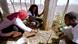 Two women and a man bring small seedlings to a vegetable patch Two women and a man bring small seedlings to a vegetable patch