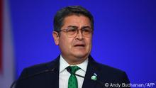 (FILES) In this file photo taken on November 1, 2021, Honduras' President Juan Orlando Hernandez presents his national statement as part of the World Leaders' Summit of the COP26 UN Climate Change Conference in Glasgow, Scotland. - US requested Honduras to extradite former president Juan Orlando Hernandez (2014-2022), who is accused of drug trafficking, official sources close to the process informed AFP on February 14, 2022. (Photo by ANDY BUCHANAN / POOL / AFP)
