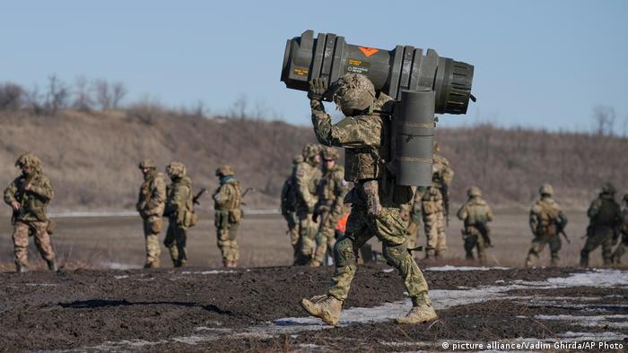 A Ukrainian serviceman carries an anti-tank weapons in Donetsk