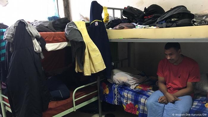 A man sits on a bunkbed