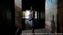A pregnant 16 year old teenager mother, stands in the hallway of her residence in the poverty stricken Mbare township in Harare, Zimbabwe