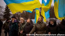 Women hold Ukrainian flags as they gather to celebrate a Day of Unity in Odessa, Ukraine, Wednesday, Feb. 16, 2022. As Western officials warned a Russian invasion could happen as early as today, the Ukrainian President Zelenskyy called for a Day of Unity, with Ukrainians encouraged to raise Ukrainian flags across the country. (AP Photo/Emilio Morenatti)