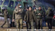 Ukrainian President Volodymyr Zelenskyy, center, arrives to attend a military drill outside the city of Rivne, northern Ukraine, Wednesday, Feb. 16, 2022. (Ukrainian Presidential Press Office via AP)