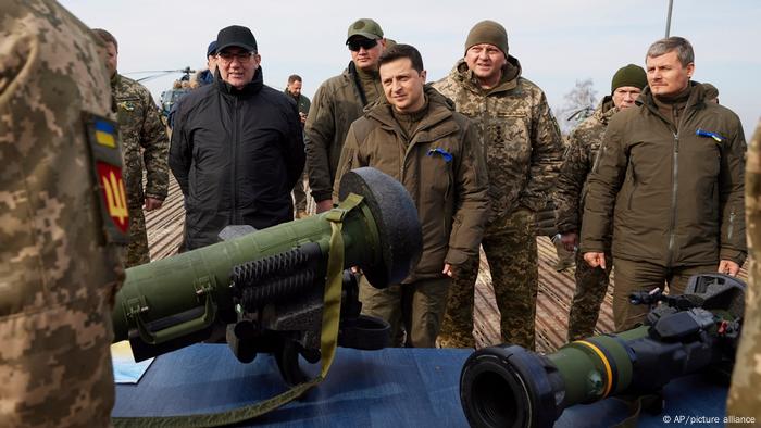 Ukrainian president Zelenskyy (centre) surrounded by several soldiers, with anti-tank weapons in the foreground, at a military drill in Rivne, northern Ukraine on February 16, 2022