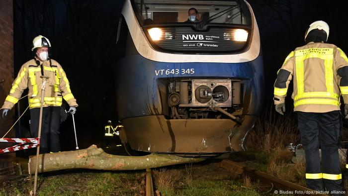 Firefighters clear a tree from underneath the Nordwestbahn railcar near Dorsten in NRW. 