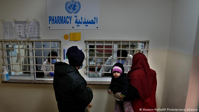 Palestinians receive medicine from a pharmacy run by the agency for Palestinian refugees, UNWRA, in Lebanon.