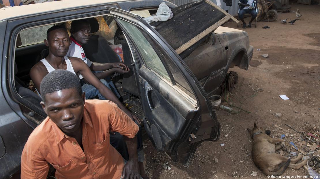 Three young Nigerians waiting for work