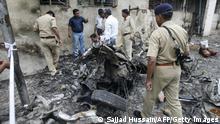 Indian forensic experts collect evidence from the blast site outside the Civil Hospital in Ahmedabad on July 27, 2008. Indian leaders issued appeals for calm after a wave of bombings killed 38 people and left 100 injured in the religiously-tense western city of Ahmedabad. AFP PHOTO/ Sajjad HUSSAIN (Photo credit should read SAJJAD HUSSAIN/AFP via Getty Images)