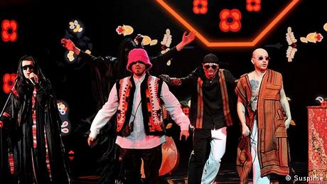 Kalush Orchestra: Band members wearing clothes combining hip hop and folkloric styles perform.