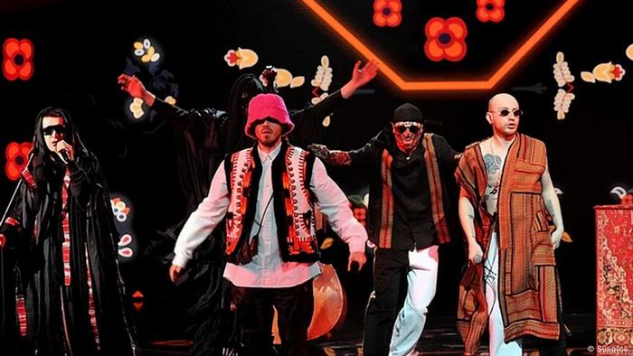 Kalush Orchestra: Band members wearing clothes combining hip hop and folkloric styles perform.