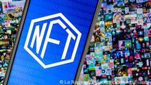 December 21, 2021: Kazan, Russia - April 03, 2021: NFT (non-fungible token) symbol on screen smartphone. On background Beeple digital art EVERYDAYS: THE FIRST 5000 DAYS. (Credit Image: © La Nacion via ZUMA Press