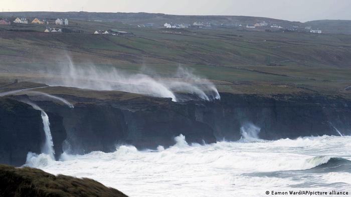 High winds push gusts of water up high cliffs in County Clare, Ireland