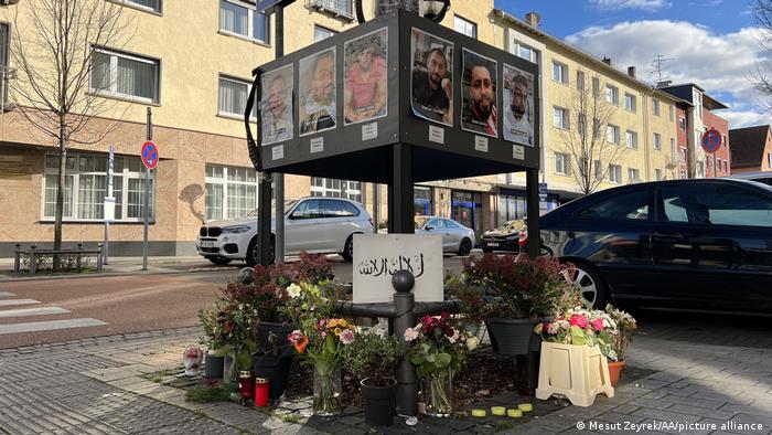 Flowers are laid and photos posted to a makeshift memorial to the Hanau shooting victims