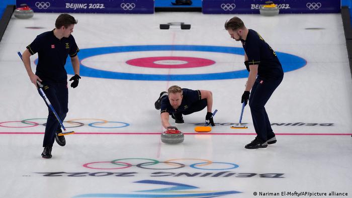 Sweden's Niklas Edin throws a rock during the men's curling final match