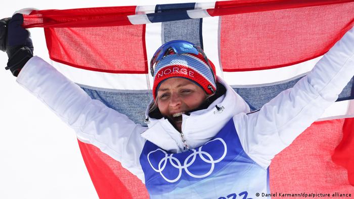 Therese Johaug celebrates with a Norwegian flag