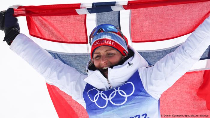 Therese Johaug celebrates with a Norwegian flag