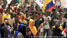 Demonstrators march with flags of Sudan and Venezuela (without the stars) during ongoing protests calling for civilian rule and denouncing the military administration, in the Sahafa neighbourhood in the south of Sudan's capital Khartoum on February 20, 2022. (Photo by Ebrahim Hamid / AFP) (Photo by EBRAHIM HAMID/AFP via Getty Images)