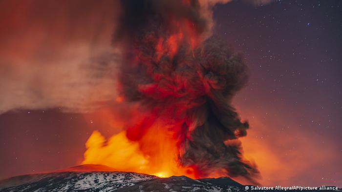 Lava and ash from Mount Etna color the night sky