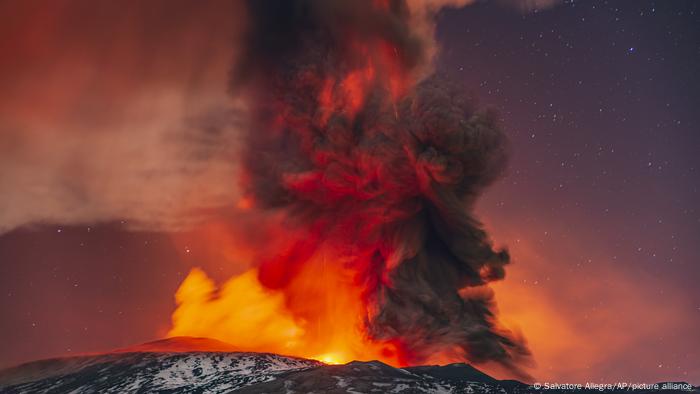 Lava and ash from Mount Etna color the night sky