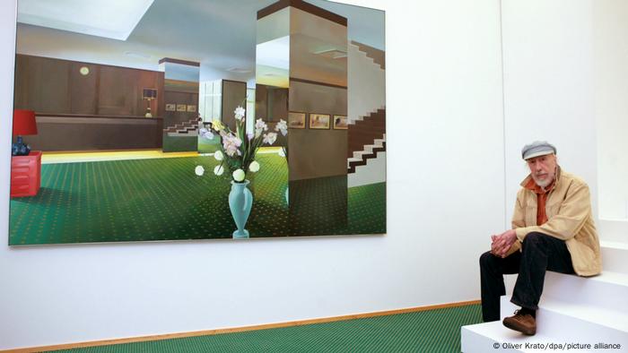 Richard Hamilton sitting in front of one of his works titled Lobby.