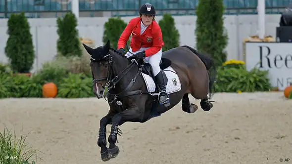 Janne-Friederike Meyer mit ihrem Pferd Lambrasco beim Sprung über den Wassergraben. Foto: AP