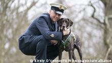 22.02.2022, Großbritannien, London: Former handler and trainer RAF Police Warrant Officer Jonathan Tanner with retired RAF Police sniffer dog, Hertz, in Green Park, central London, with his People's Dispensary for Sick Animals (PDSA) Dickin Medal for valour, the highest award any animal can receive whilst serving in military conflict. Hertz received the award after for finding more than 100 items of contraband, including drugs and Personal Electronic Devices (PEDs), all of which posed a significant threat to the lives of servicemen, women and civilians in Afghanistan. Picture date: Tuesday February 22, 2022. Foto: Kirsty O'connor/PA Wire/dpa
