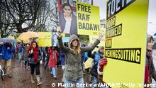People take part in a protest by Amnesty International, for the immediate release of the Saudi blogger Raif Badawi, in front of the Saudi Embassy in The Hague, on January 15, 2015. Badawi put on the website 'Freed Saudi liberals and was arrested in 2012. He was sentenced to ten years in prison, converted 226,000 euro fine and a thousand lashes. AFP PHOTO / ANP / MARTIJN BEEKMAN ***netherlands out*** (Photo credit should read Martijn Beekman/AFP via Getty Images)