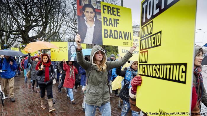People take part in a protest by Amnesty International, for the immediate release of the Saudi blogger Raif Badawi, in front of the Saudi Embassy in The Hague, on January 15, 2015.