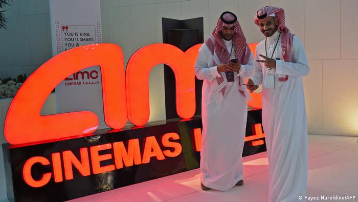 A Saudi man poses for a photograph during a cinema test screening in Riyadh on April 18, 2018. 