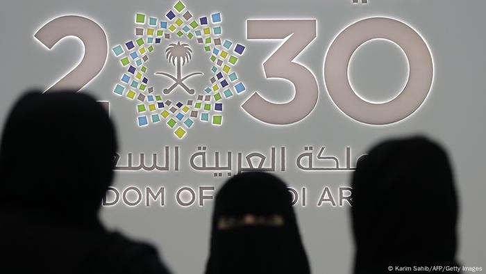 Saudi women stand next to the Saudi pavilion (vision 2030) at the Gitex 2018 exhibition at the Dubai World Trade Center in Dubai on October 16, 2018.